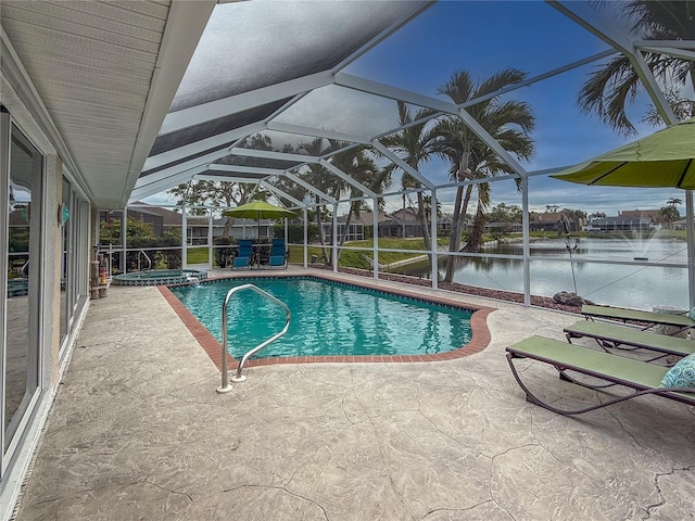 view of pool with glass enclosure, a patio area, a water view, and an in ground hot tub