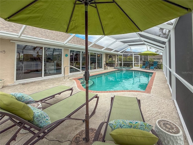 view of swimming pool with a patio area and a lanai