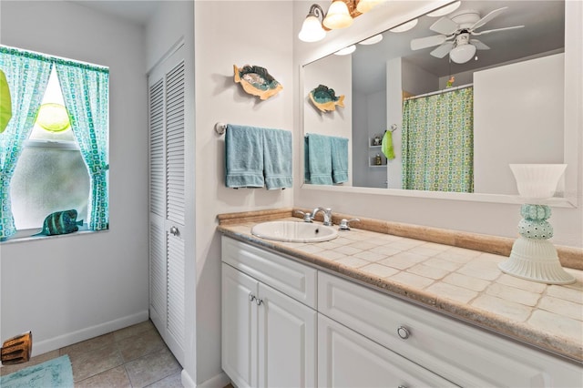 bathroom featuring ceiling fan, vanity, and tile patterned flooring