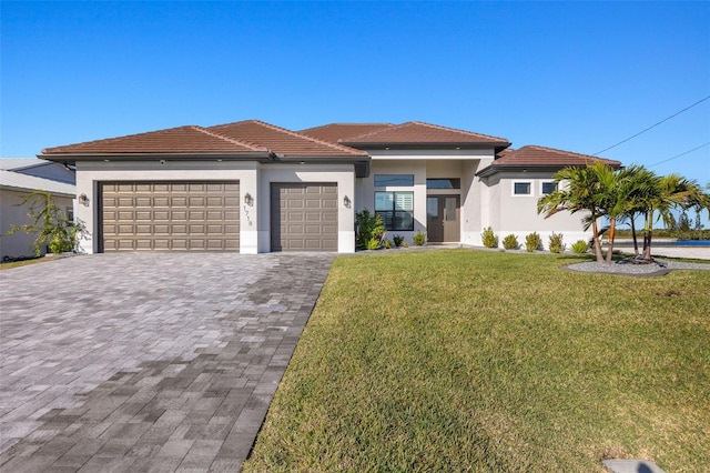 view of front of property featuring a garage and a front lawn