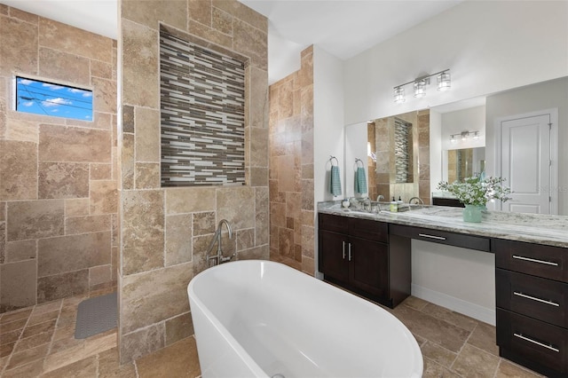 bathroom featuring vanity and a washtub