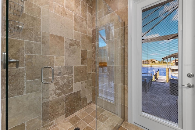 bathroom with a shower with door