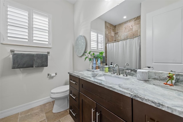 bathroom with vanity, walk in shower, and toilet