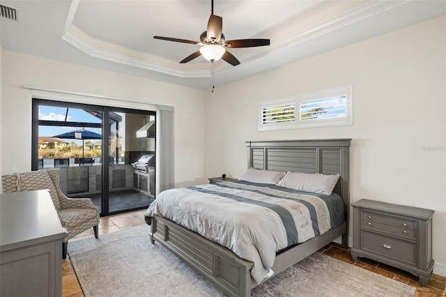 bedroom with multiple windows, a tray ceiling, access to outside, and ceiling fan