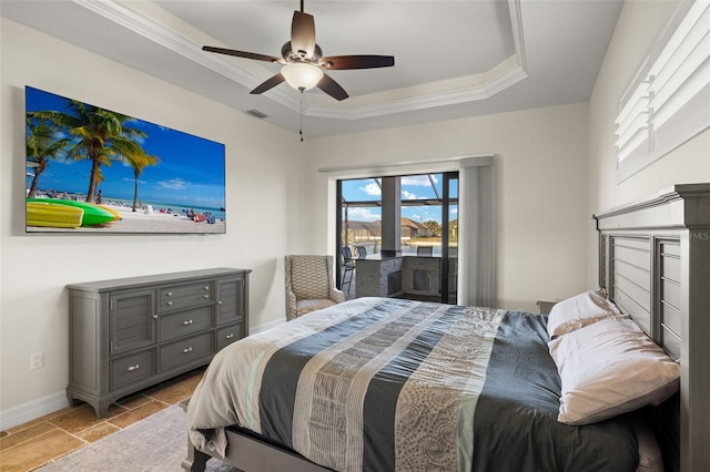 bedroom featuring ceiling fan, ornamental molding, a raised ceiling, and access to outside