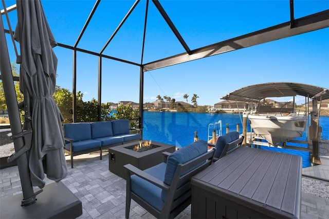 dock area featuring a lanai, a water view, an outdoor living space with a fire pit, and a patio area