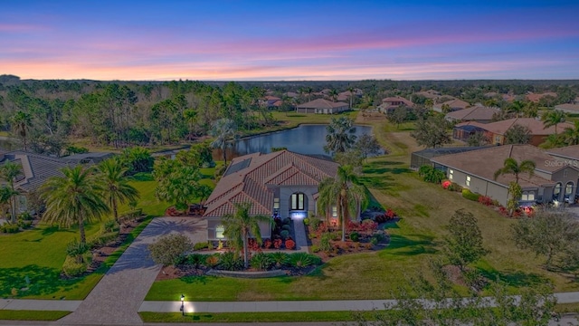 aerial view at dusk with a water view