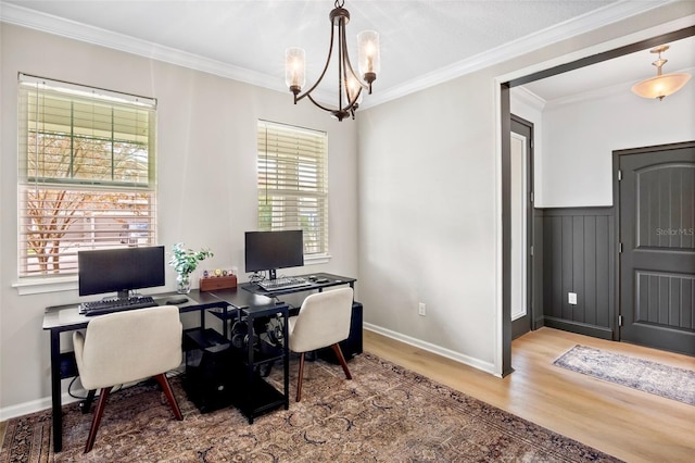 office area with hardwood / wood-style floors, ornamental molding, and a notable chandelier