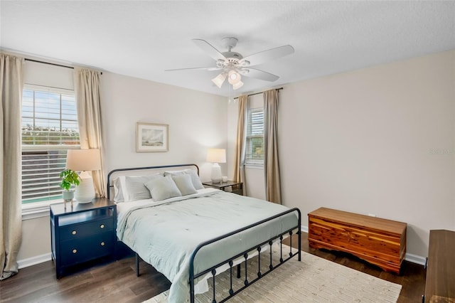 bedroom with ceiling fan and dark wood-type flooring