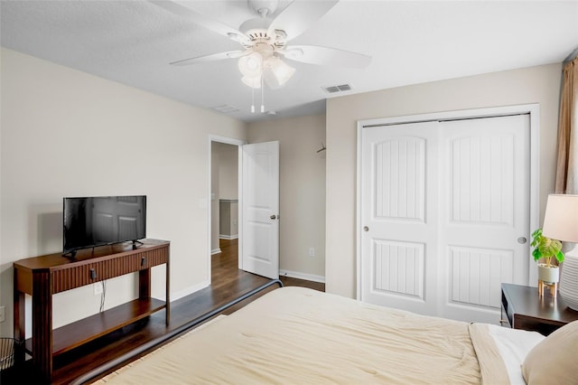 bedroom featuring ceiling fan, a closet, and dark hardwood / wood-style floors