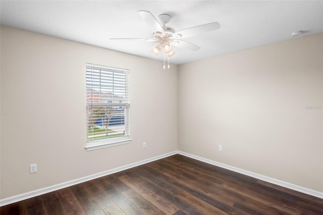 empty room featuring ceiling fan and dark hardwood / wood-style flooring