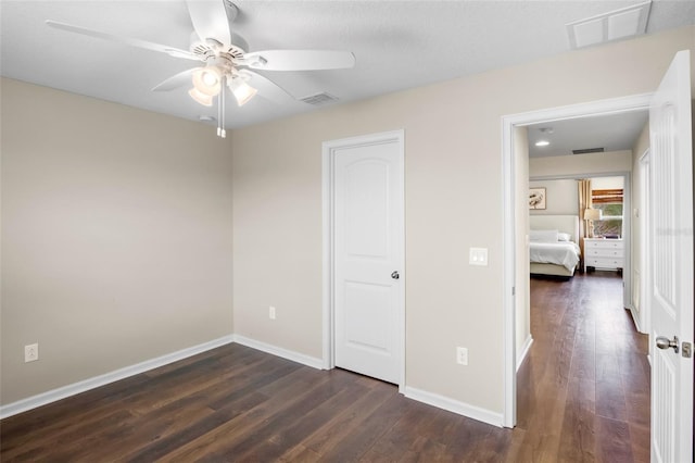 unfurnished bedroom with ceiling fan and dark hardwood / wood-style floors