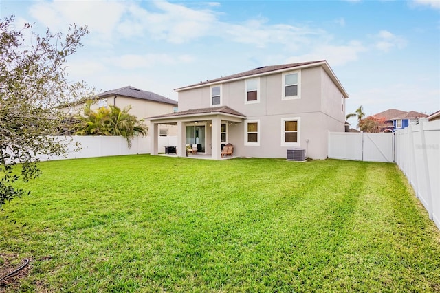 rear view of property with a patio, a lawn, and central air condition unit