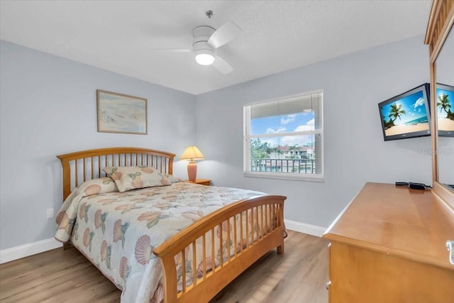 bedroom featuring ceiling fan and hardwood / wood-style flooring