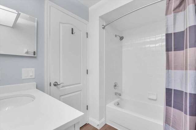 bathroom featuring shower / bathtub combination with curtain, wood-type flooring, and vanity