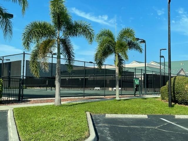 view of sport court featuring a yard