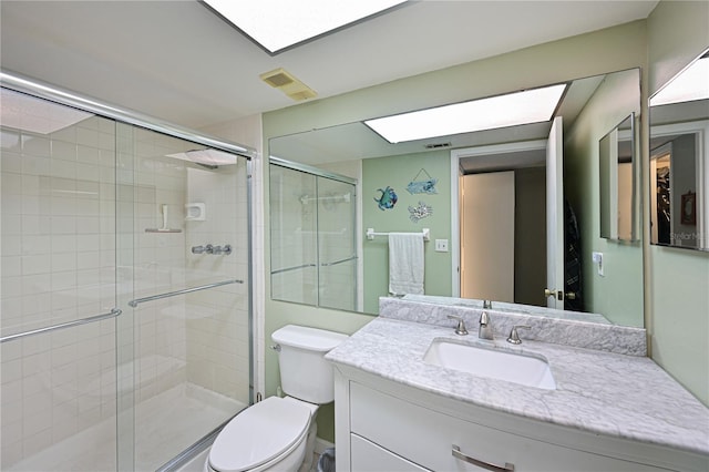 bathroom with toilet, walk in shower, and vanity