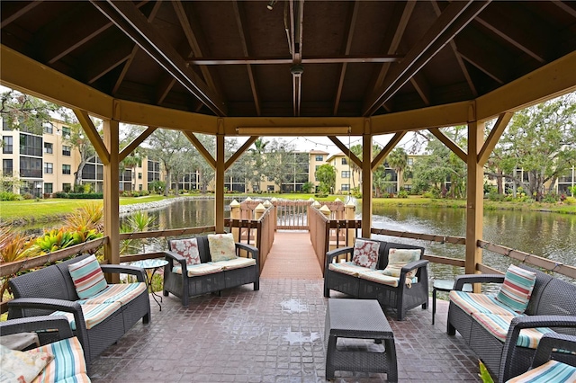 view of patio / terrace featuring a water view, a gazebo, and an outdoor living space