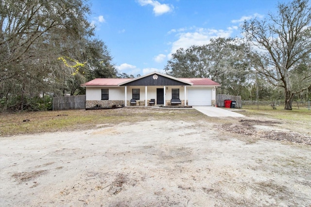 ranch-style house featuring a porch and a garage