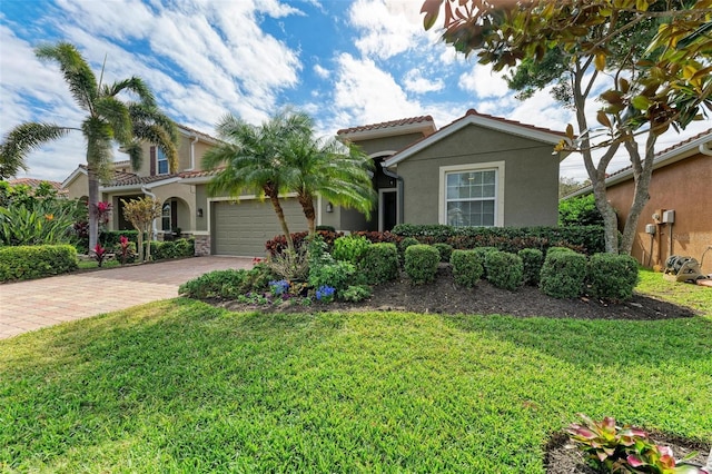 view of front of property with a garage and a front yard