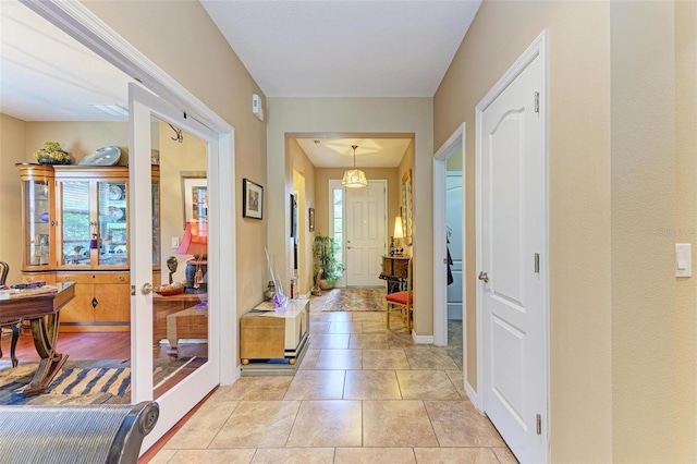 tiled foyer entrance featuring french doors