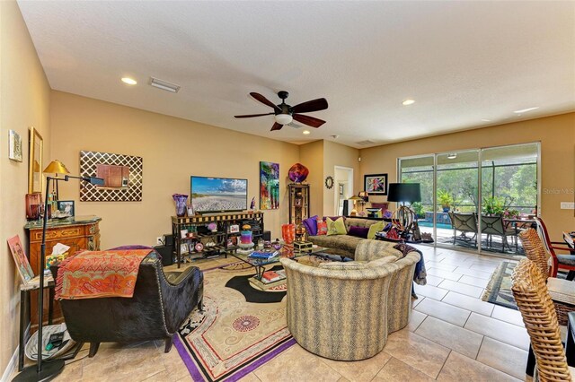 tiled living room with ceiling fan