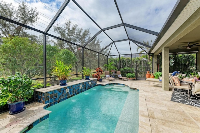 view of swimming pool featuring pool water feature, a patio area, ceiling fan, and a lanai