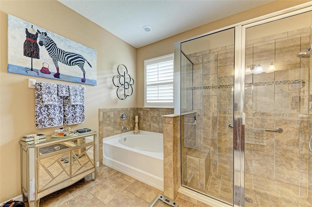 bathroom featuring tile patterned flooring and separate shower and tub