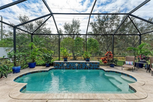 view of swimming pool featuring a lanai, a patio area, and pool water feature