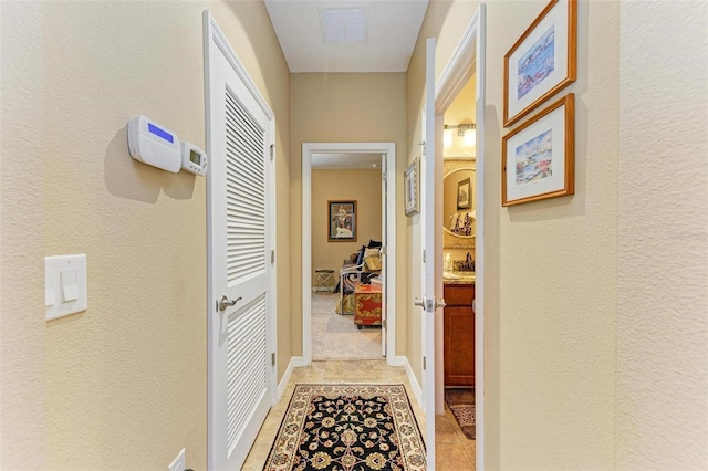 hallway with light tile patterned floors