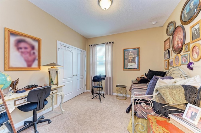 home office with light carpet and a textured ceiling