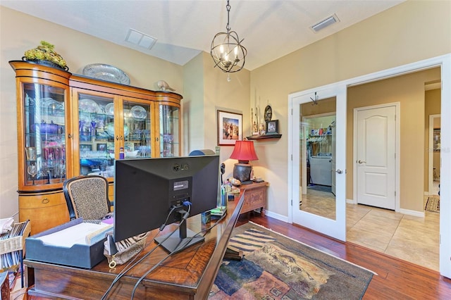 home office featuring a chandelier and hardwood / wood-style floors