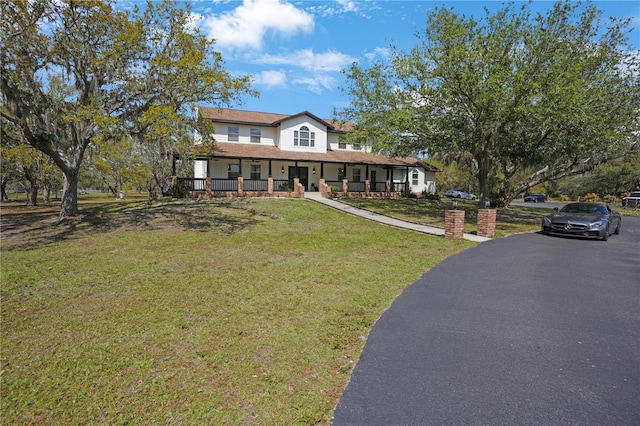 view of front of home with a front yard and covered porch