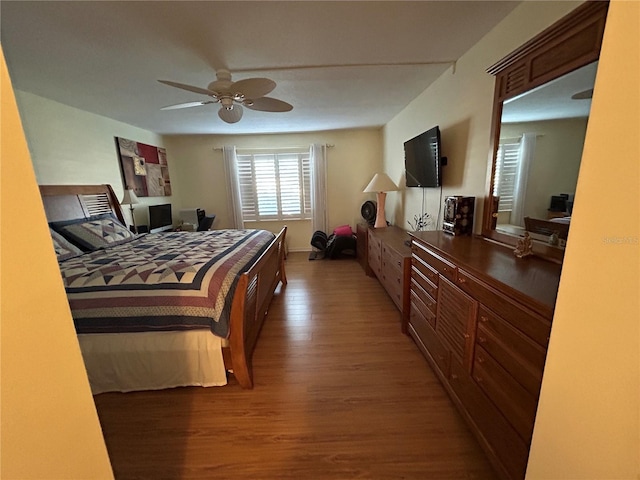 bedroom with ceiling fan and dark hardwood / wood-style flooring