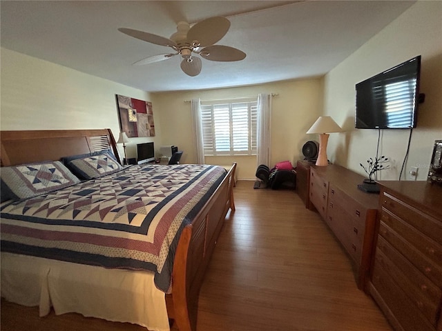 bedroom with ceiling fan and hardwood / wood-style floors