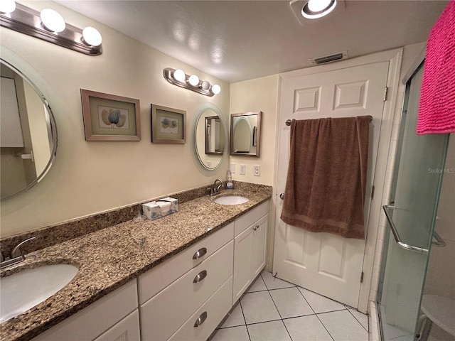 bathroom with vanity, tile patterned flooring, and a shower with door