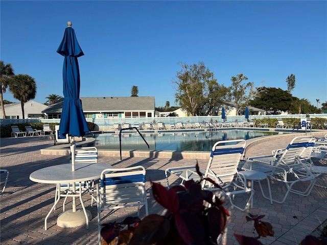 view of swimming pool featuring a water view