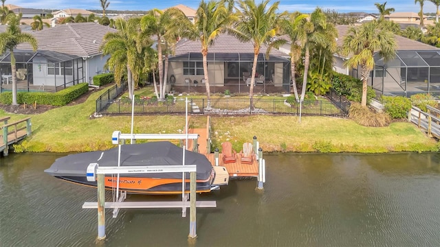 view of dock with a lanai, a lawn, and a water view