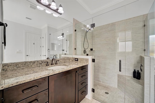 bathroom with vanity, a shower with door, and crown molding