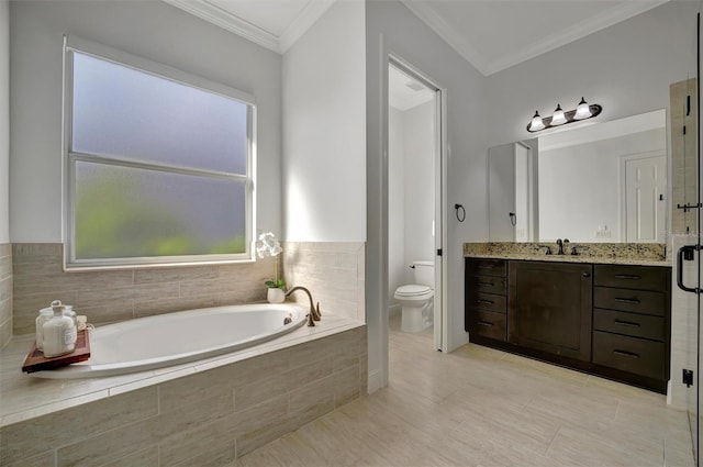 bathroom with toilet, vanity, crown molding, and tiled tub