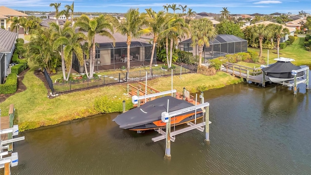 view of dock featuring glass enclosure, a water view, and a yard