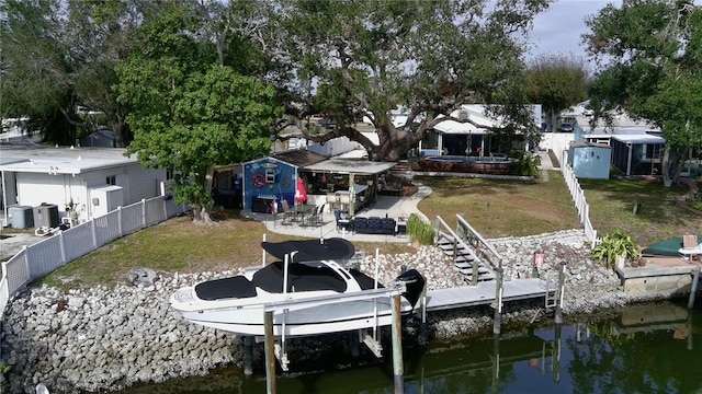 view of dock featuring a yard and a water view