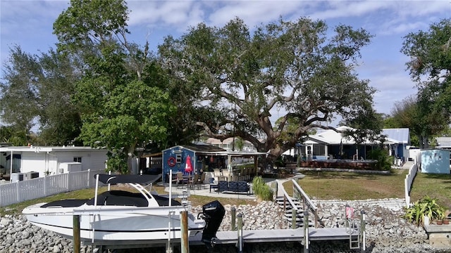 view of dock featuring a lawn