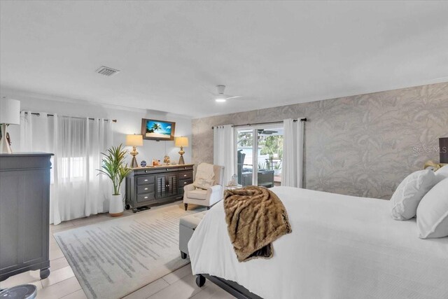 bedroom featuring ceiling fan, light tile patterned floors, and access to outside