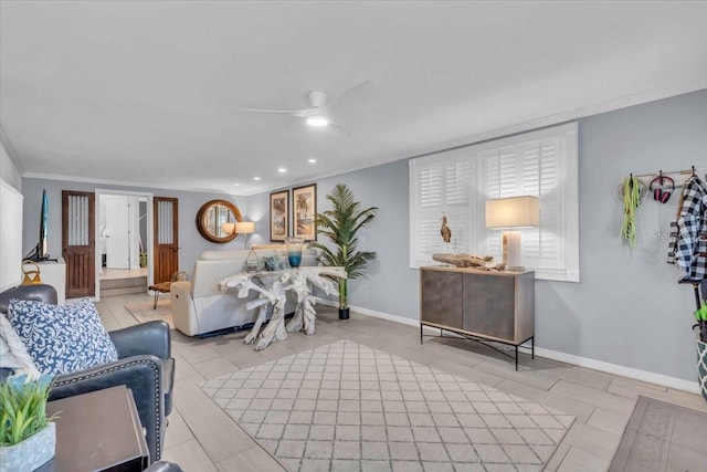 living room with ceiling fan and crown molding