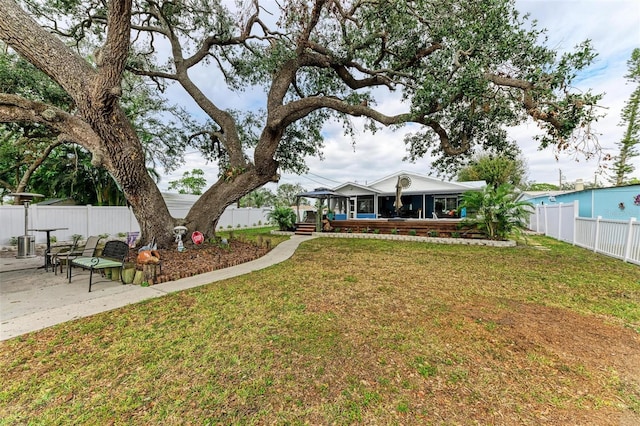 exterior space featuring a front yard and a patio