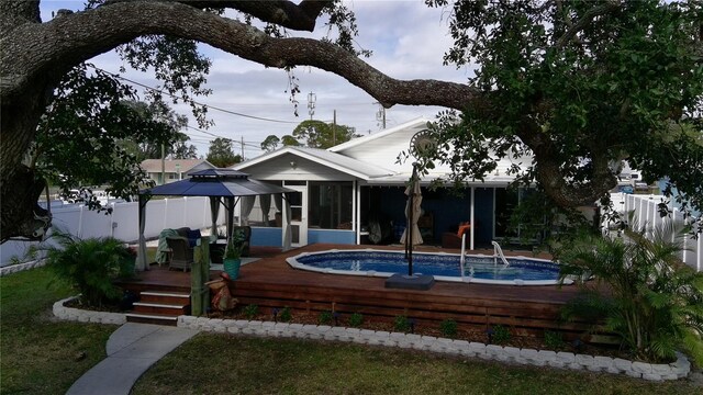 back of house featuring a deck and a sunroom