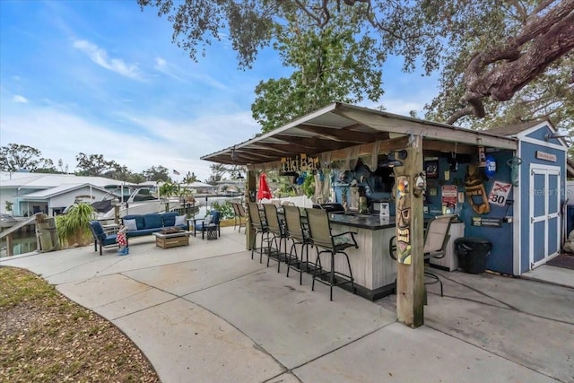 view of patio featuring outdoor lounge area and exterior bar