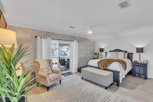 bedroom with light tile patterned floors, ceiling fan, and access to exterior