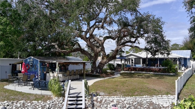 view of yard featuring a patio area and an outdoor bar